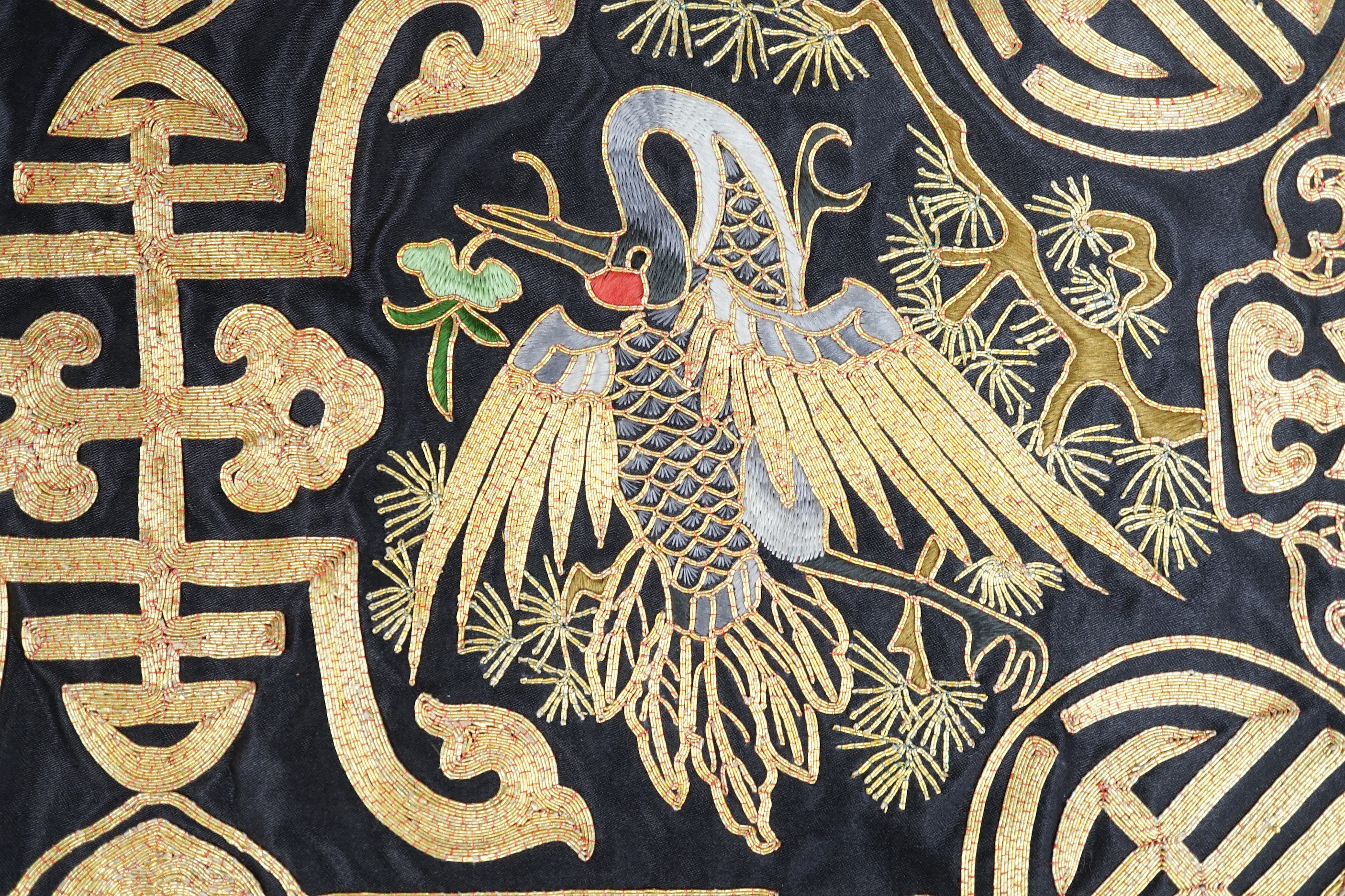 A Chinese silk textile phoenix panel embroidered with gold thread, 45cm x 25cm